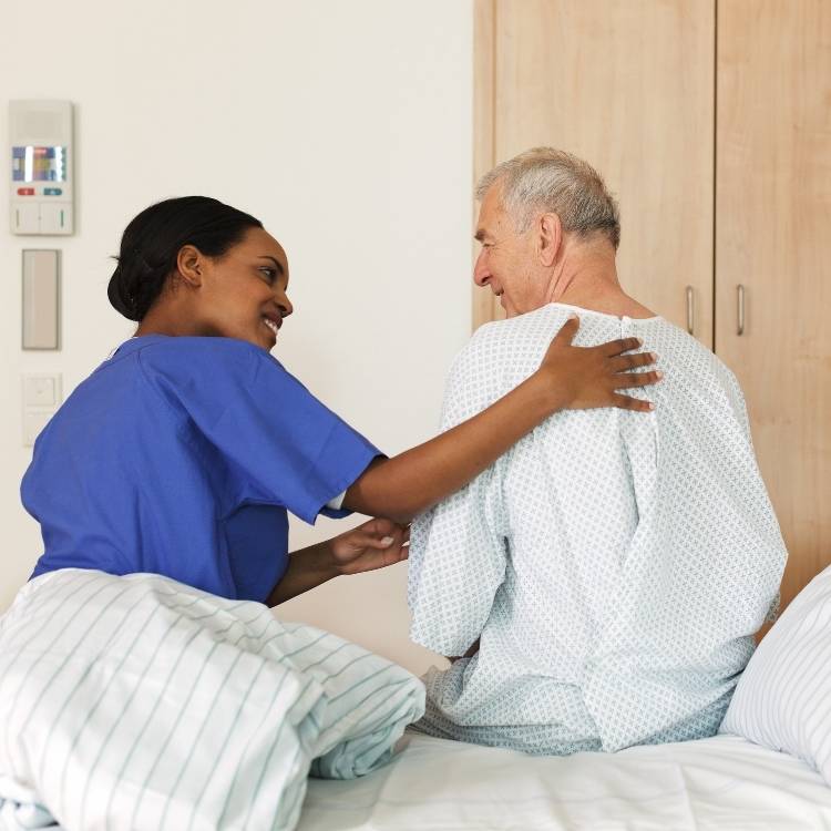 A professional nursing assistant assisting an elderly patient in daily activities, in a hospital setting.