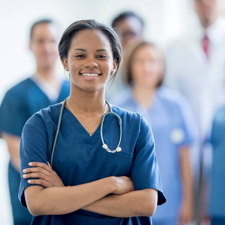 Nurse in scrubs confidently ready to attend and assit a patient